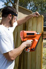 contractor building a wooden fence