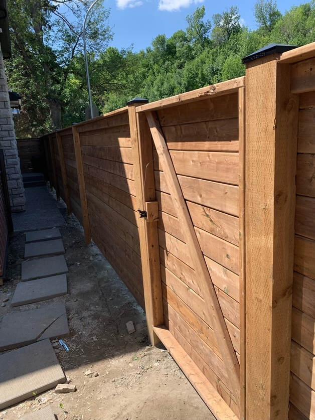 New wooden fence built with a strong gate